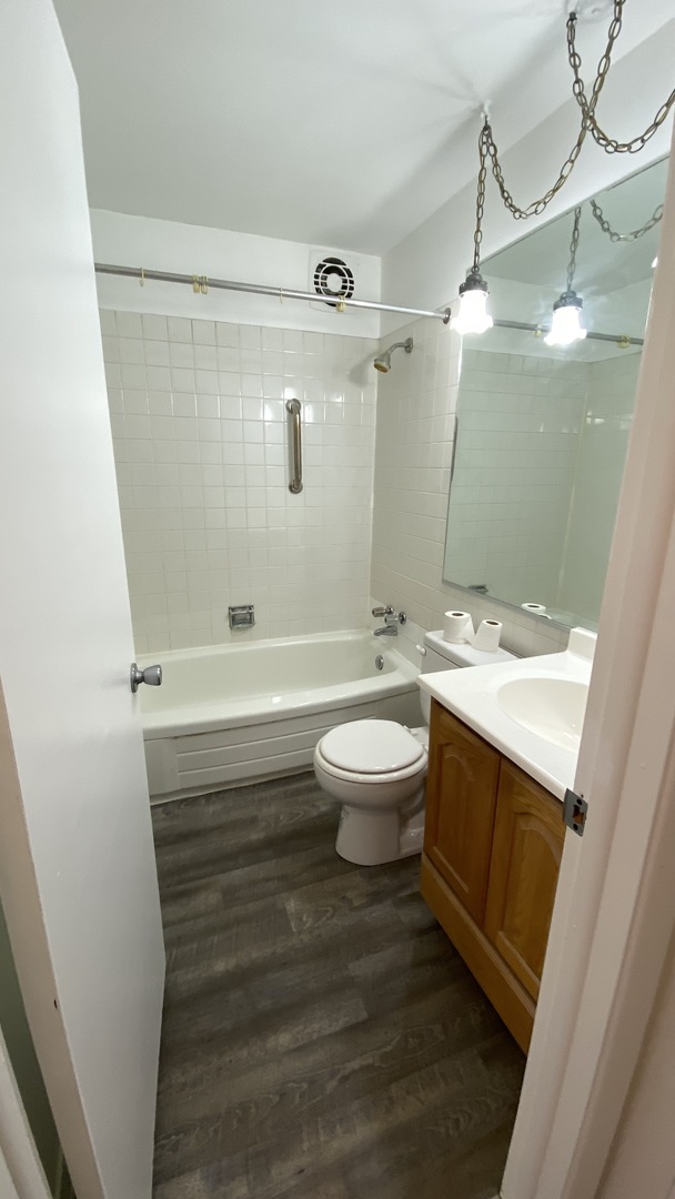 605 North Wolf Road, Unit D11 Hillside, IL 60162 - Photo 10 of 10 a bathroom with a sink a toilet and shower