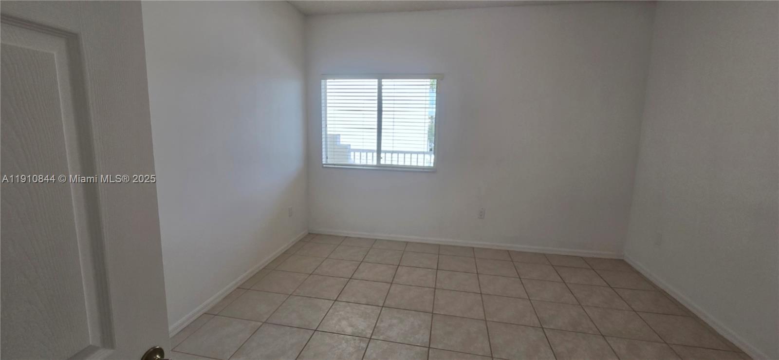 7775 Southampton Terrace, Unit 305 Tamarac, FL 33321 - Photo 12 of 39 an empty room with a empty space and window
