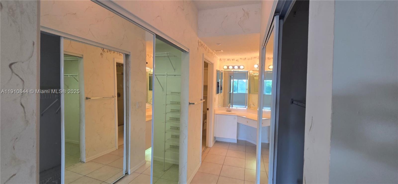 7775 Southampton Terrace, Unit 305 Tamarac, FL 33321 - Photo 22 of 39 a bathroom with a glass shower door and a sink