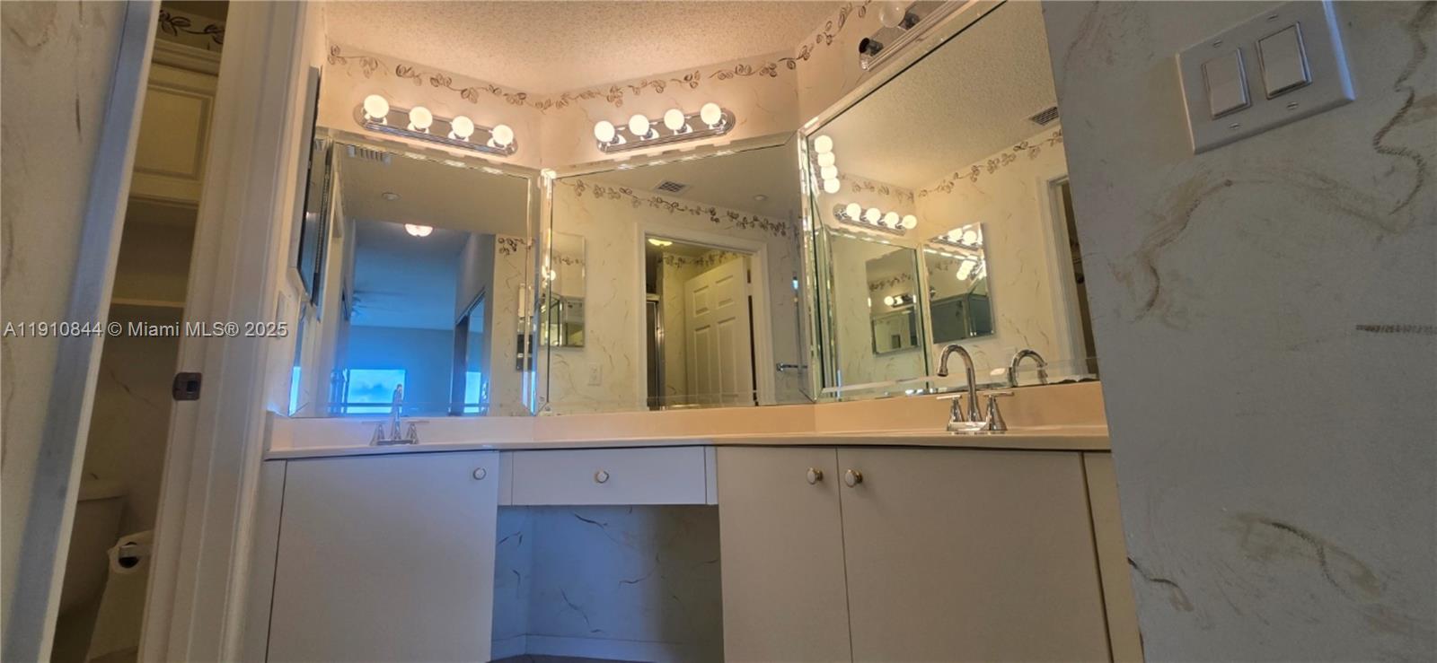 7775 Southampton Terrace, Unit 305 Tamarac, FL 33321 - Photo 26 of 39 a bathroom with a sink and a mirror