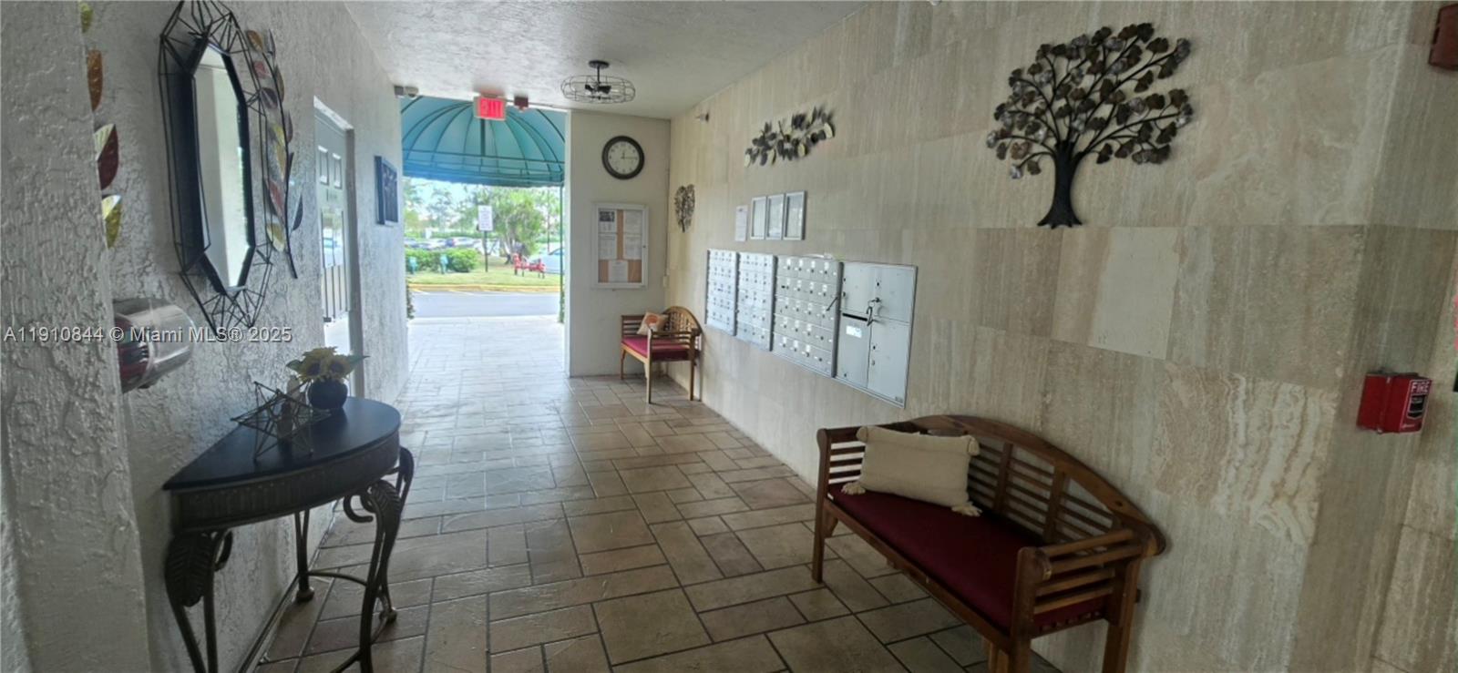 7775 Southampton Terrace, Unit 305 Tamarac, FL 33321 - Photo 34 of 39 a hallway with a potted plant and a table in it