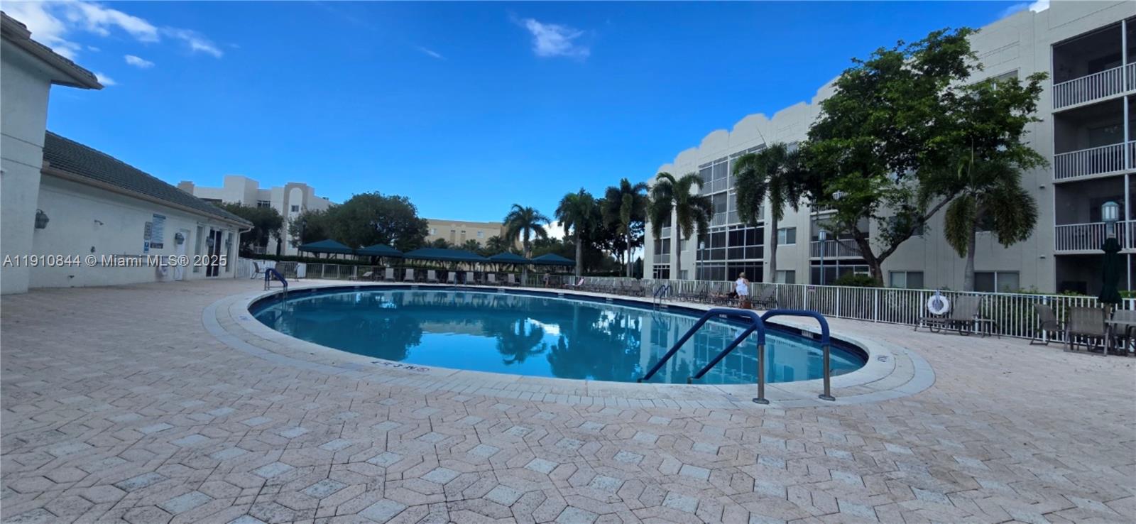7775 Southampton Terrace, Unit 305 Tamarac, FL 33321 - Photo 36 of 39 a view of swimming pool with outdoor seating and house in the background