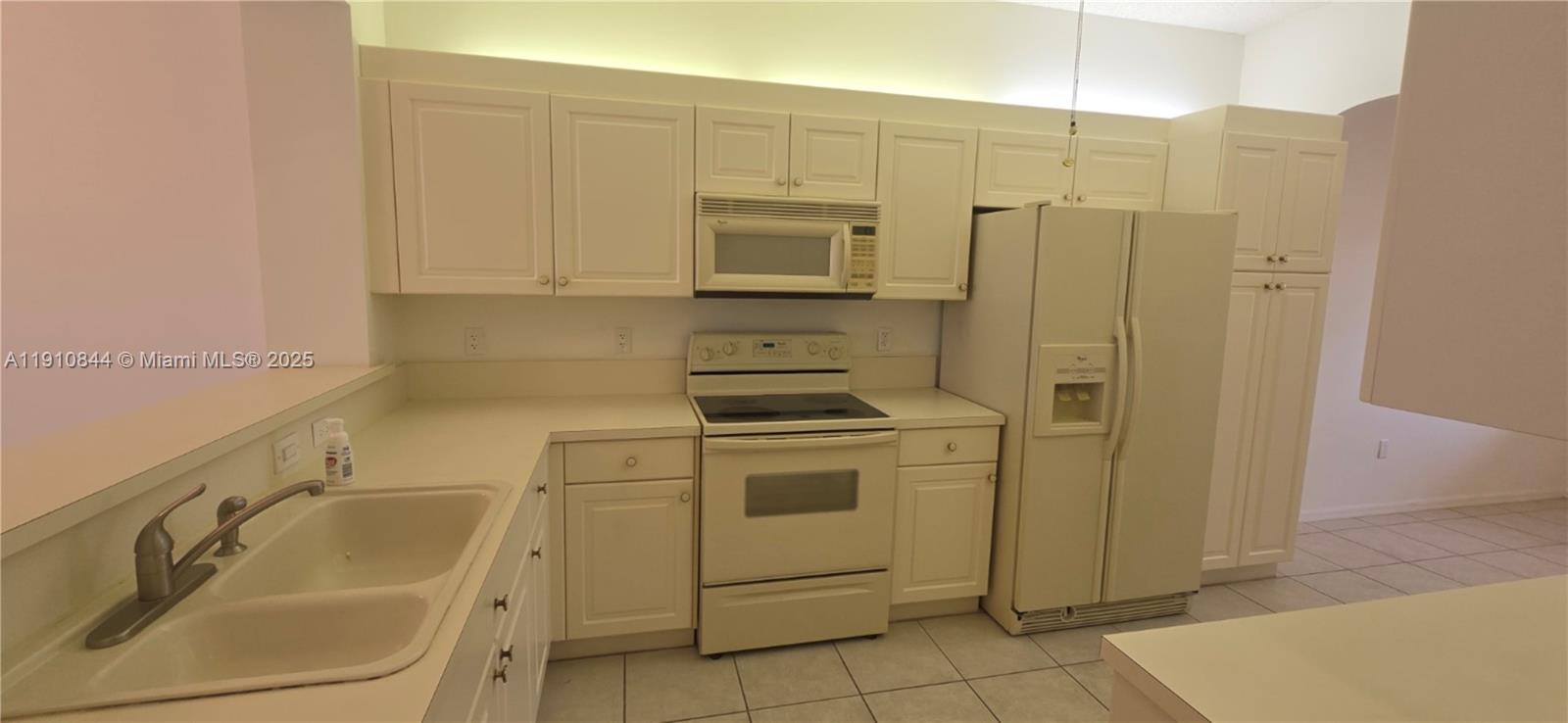 7775 Southampton Terrace, Unit 305 Tamarac, FL 33321 - Photo 7 of 39 a bathroom with a sink a washer and dryer