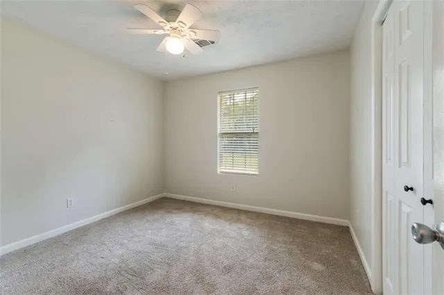 a view of a pathway both side of grassy field with shrub