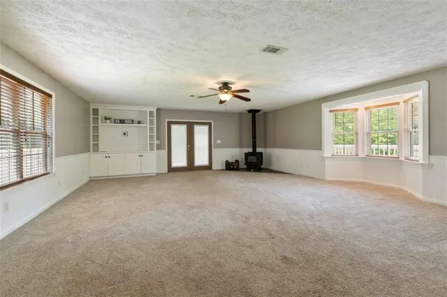 a view of a room with chandelier and windows