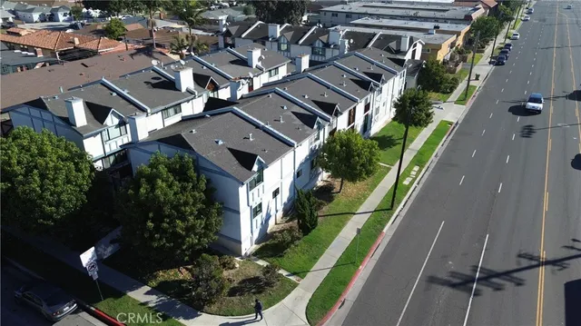 an aerial view of multiple houses with yard