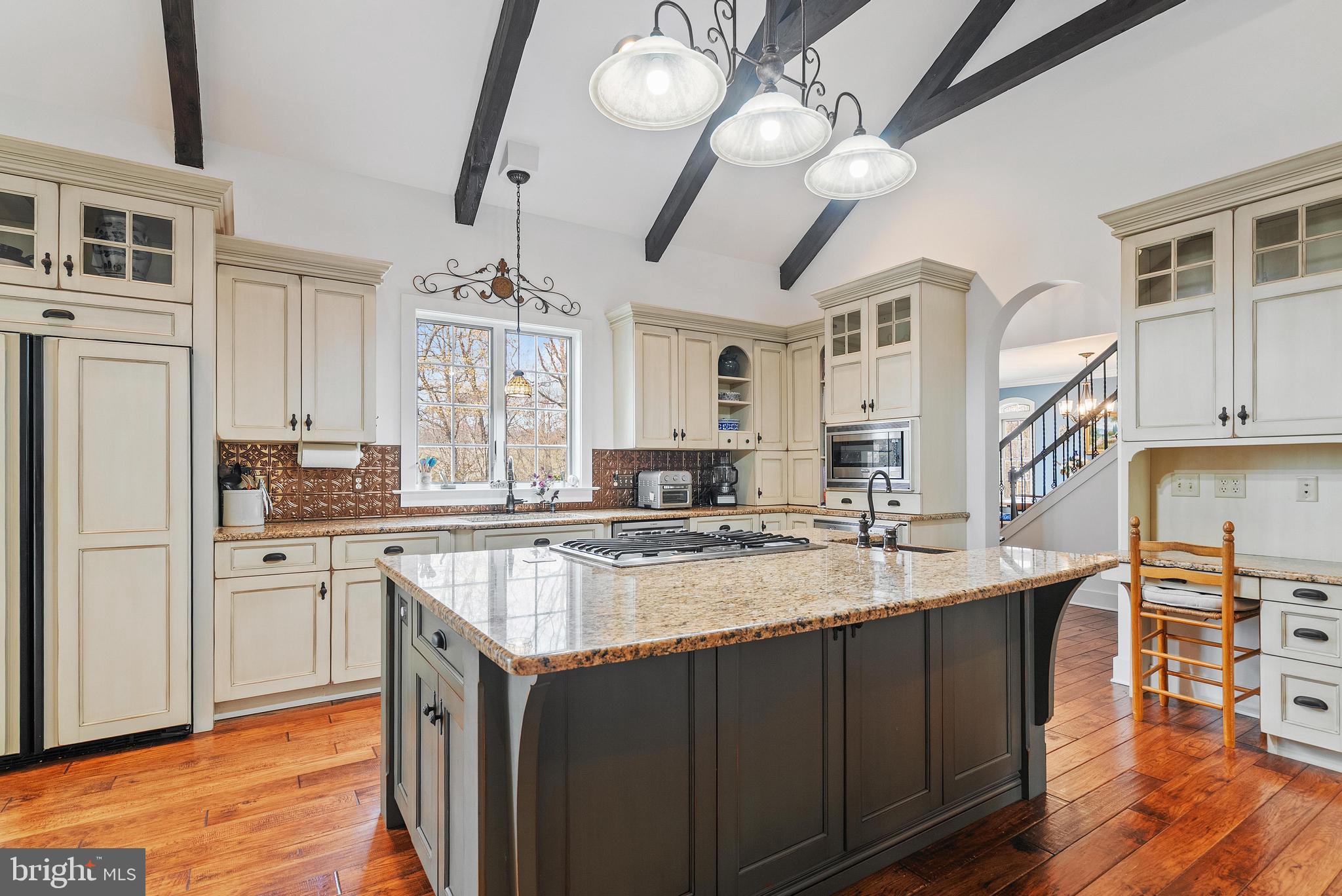 97 Wilson Road Christiana, PA 17509 - Photo 12 of 58 a kitchen with stainless steel appliances granite countertop a sink dishwasher a stove and a dining table with wooden floor