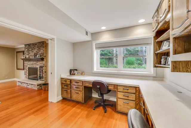 a view of a hallway with wooden floor and entryway