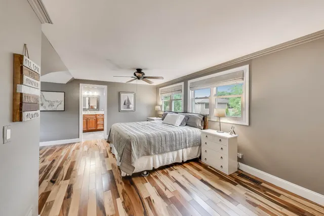 a bathroom with a granite countertop sink a toilet and a mirror