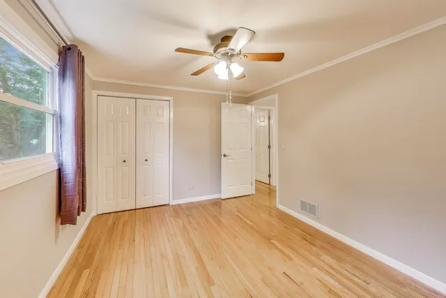 a bed room with furniture and a large window
