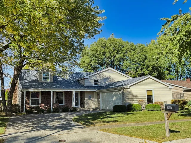 a view of a patio with table and chairs under an umbrella