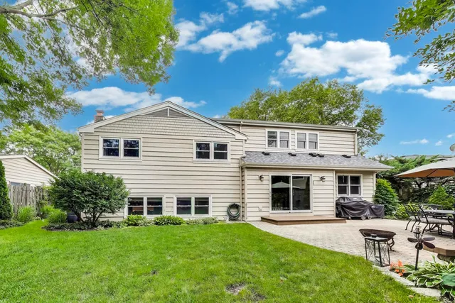 a view of a patio with a table and chairs and potted plants