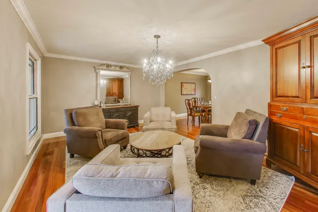 a living room with furniture and a chandelier