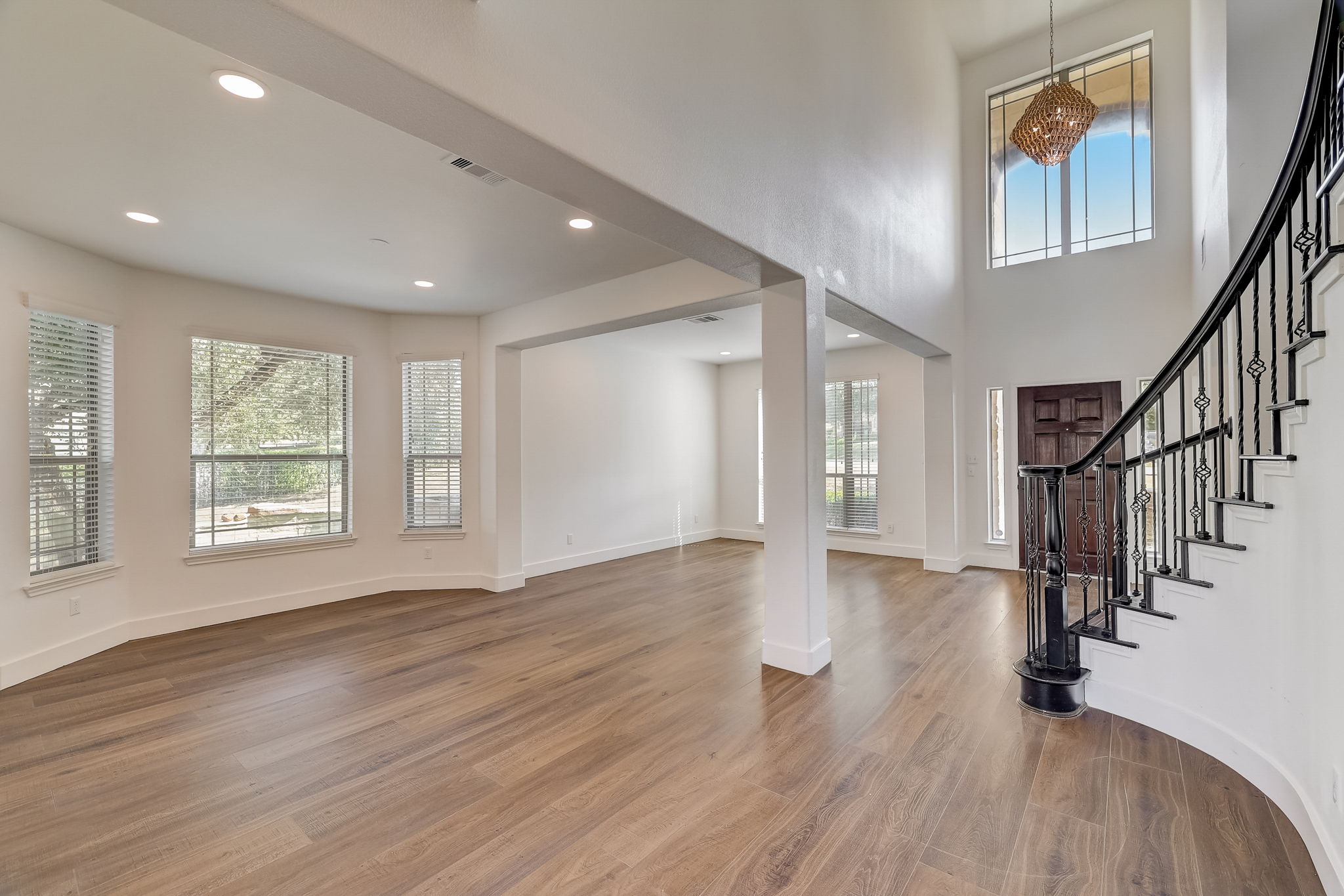16012 Spillman Ranch Loop Austin, TX 78738 - Photo 8 of 38 A grand entrance with high ceilings and a winding staircase welcomes you into this luminous living space.