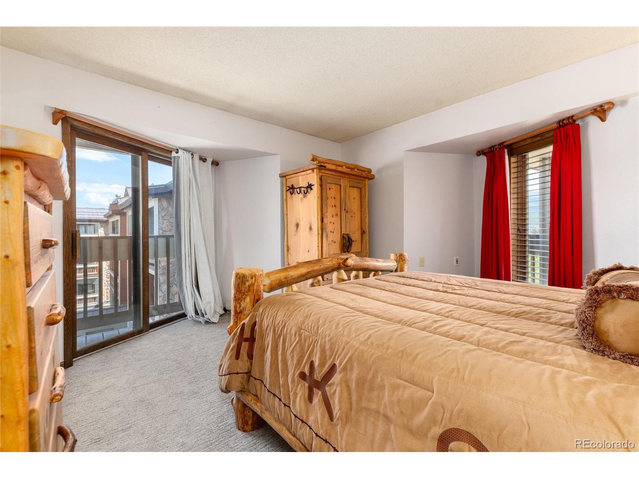 490 Kings Crossing Road, Unit 631 Winter Park, CO 80482 - Photo 26 of 43 a bedroom with a large bed and a large window