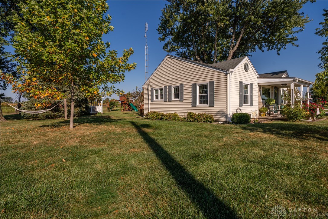 1599 Garringer Road Jamestown, OH 45335 - Photo 36 of 73 This charming home offers a serene escape with its inviting porch and spacious yard.