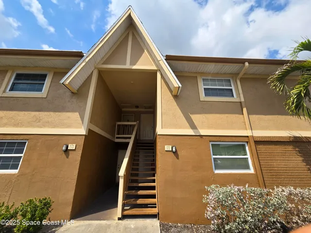 a front view of a house with stairs