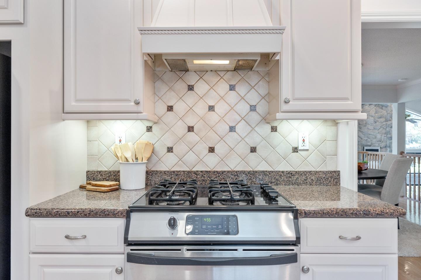 37 Vía Canon Millbrae, CA 94030 - Photo 31 of 69 a kitchen with granite countertop white cabinets and a stove