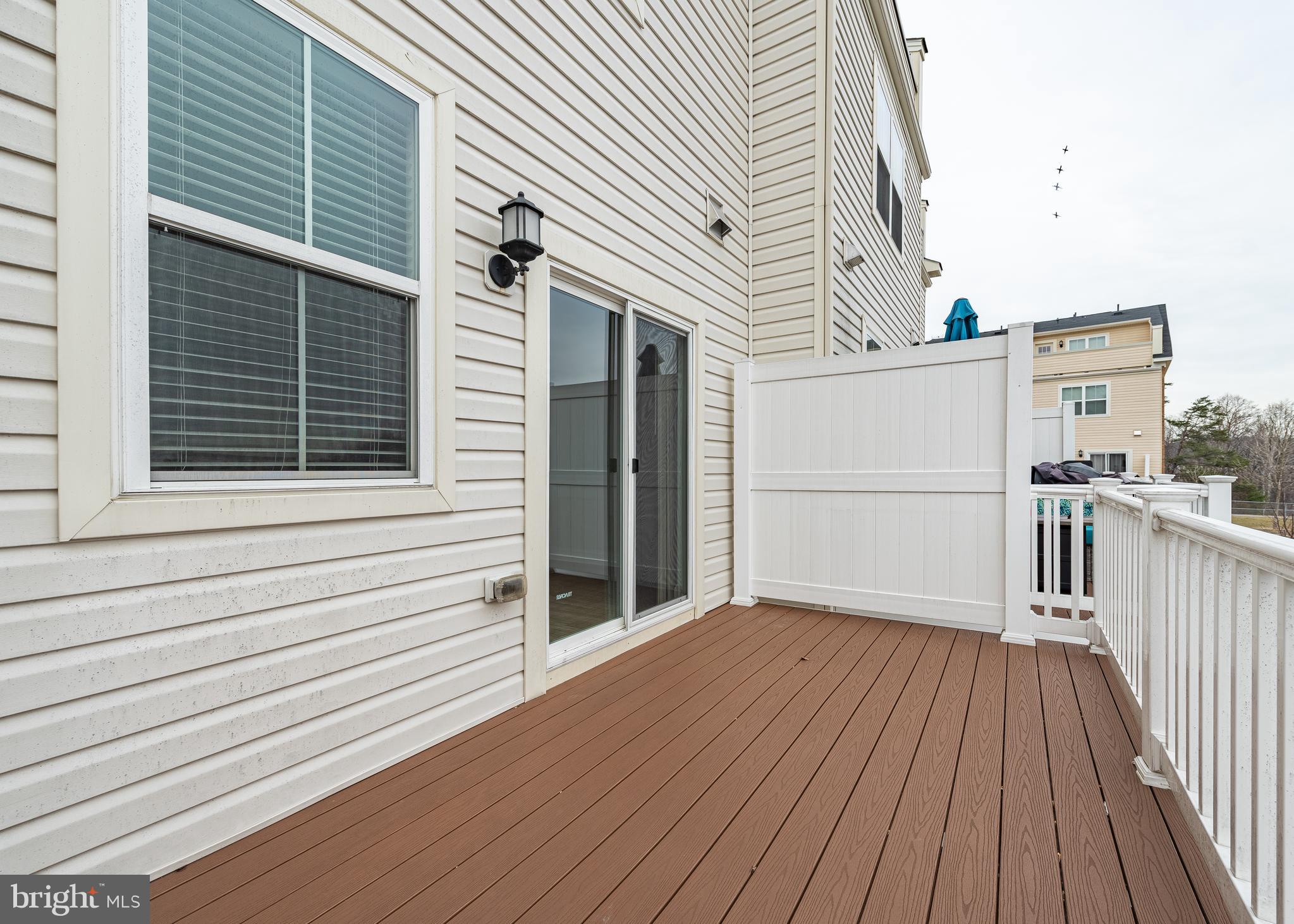 7038 Rackham Way Hanover, MD 21076 - Photo 11 of 30 a view of a house with a deck