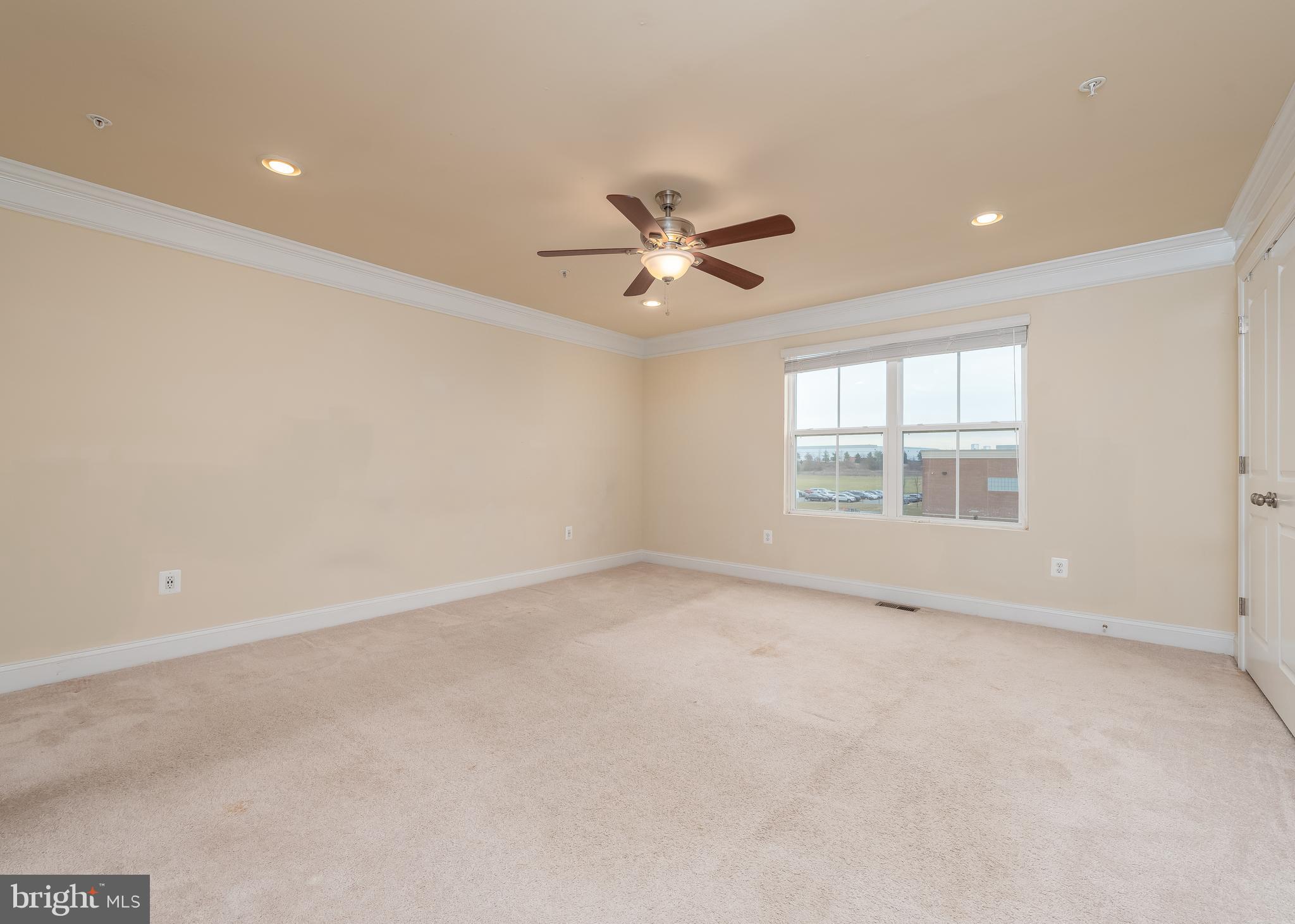 7038 Rackham Way Hanover, MD 21076 - Photo 13 of 30 an empty room with a window and a ceiling fan