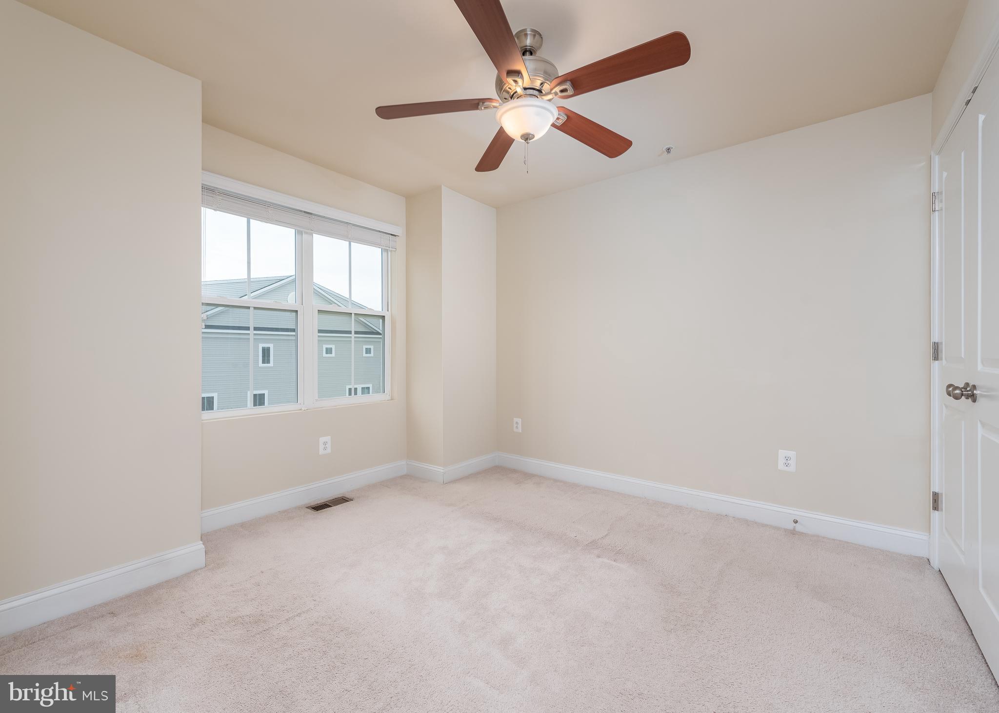 7038 Rackham Way Hanover, MD 21076 - Photo 15 of 30 an empty room with windows and fan