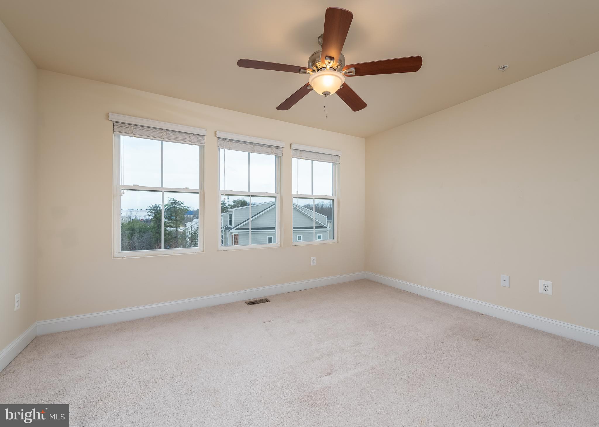 7038 Rackham Way Hanover, MD 21076 - Photo 17 of 30 an empty room with a window and a fan