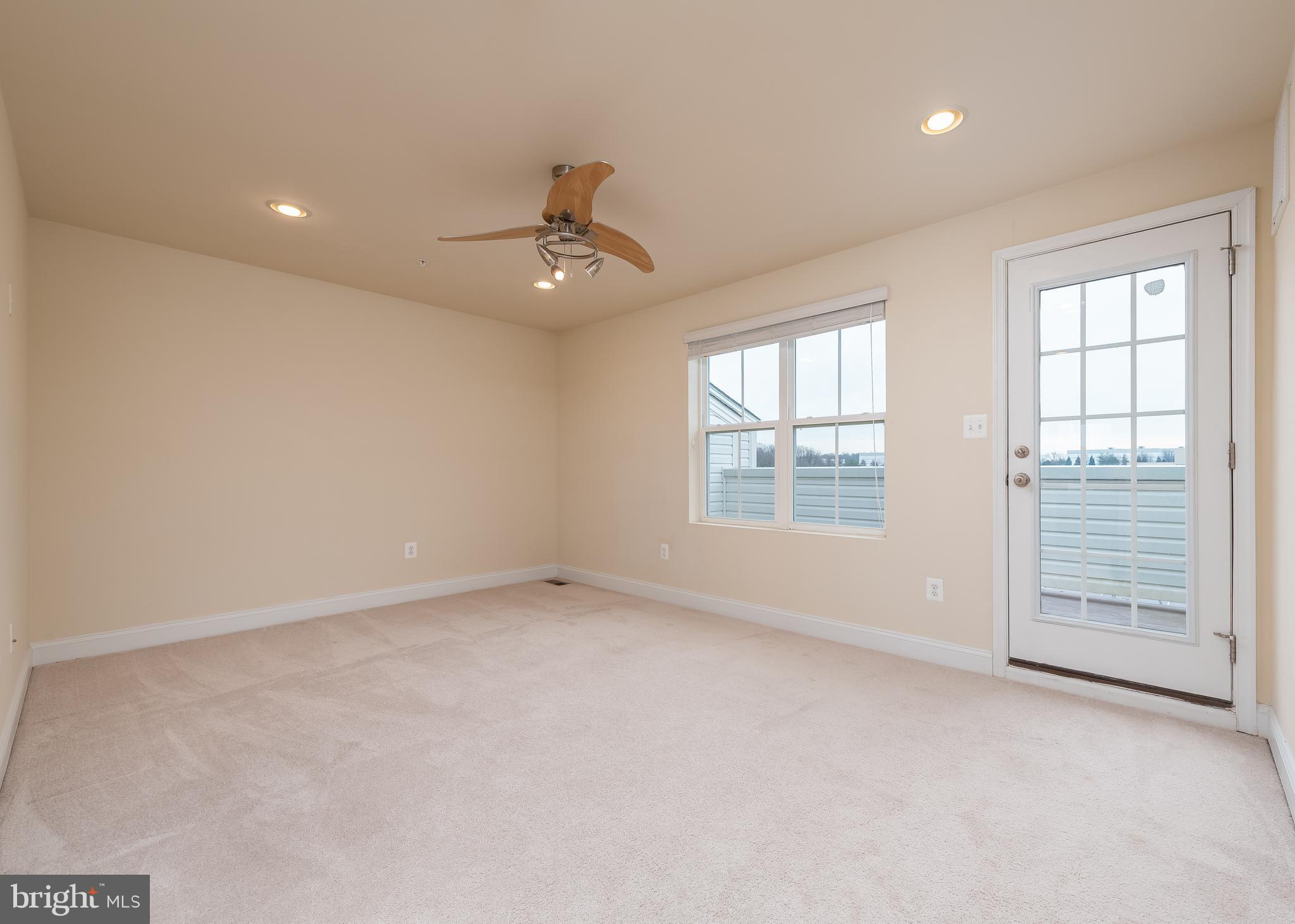 7038 Rackham Way Hanover, MD 21076 - Photo 19 of 30 an empty room with windows and fan