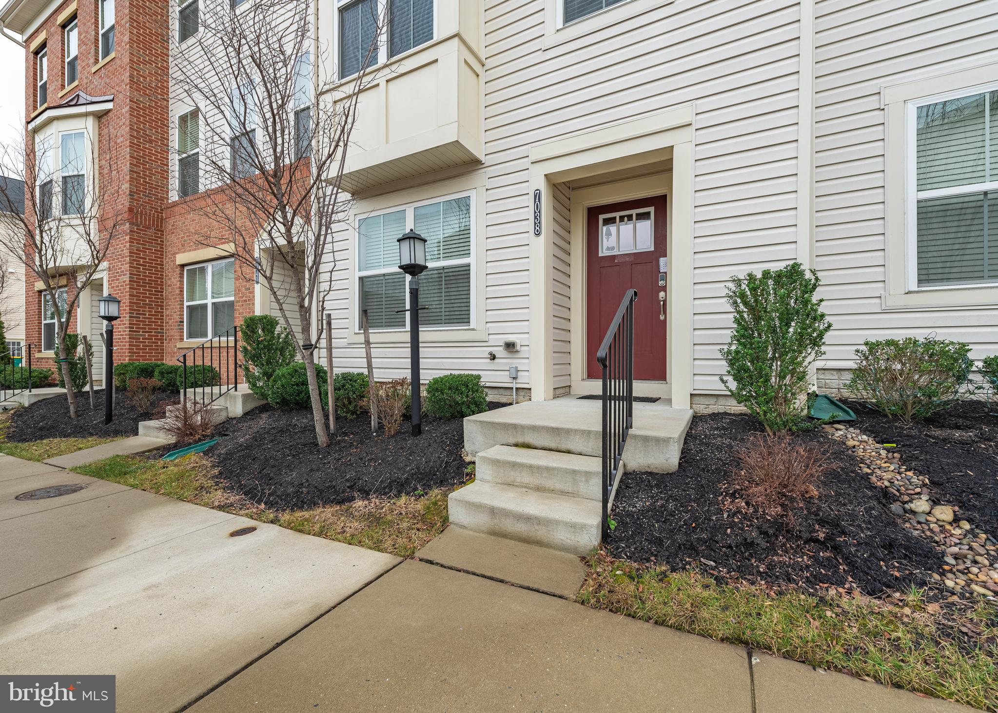 7038 Rackham Way Hanover, MD 21076 - Photo 2 of 30 a front view of a house with garden