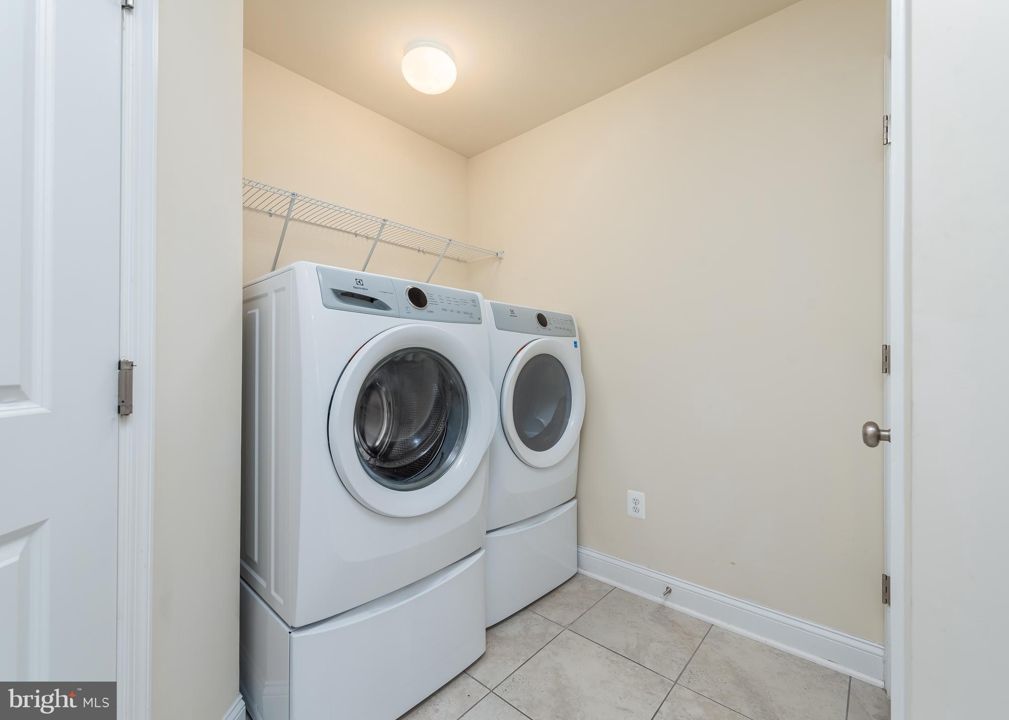 7038 Rackham Way Hanover, MD 21076 - Photo 23 of 30 a utility room with dryer and washer
