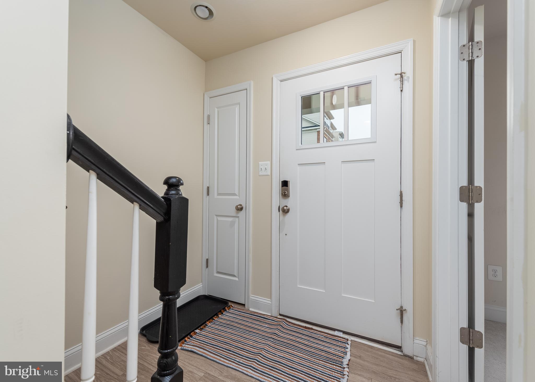 7038 Rackham Way Hanover, MD 21076 - Photo 3 of 30 a view of a hallway with wooden floor and closet