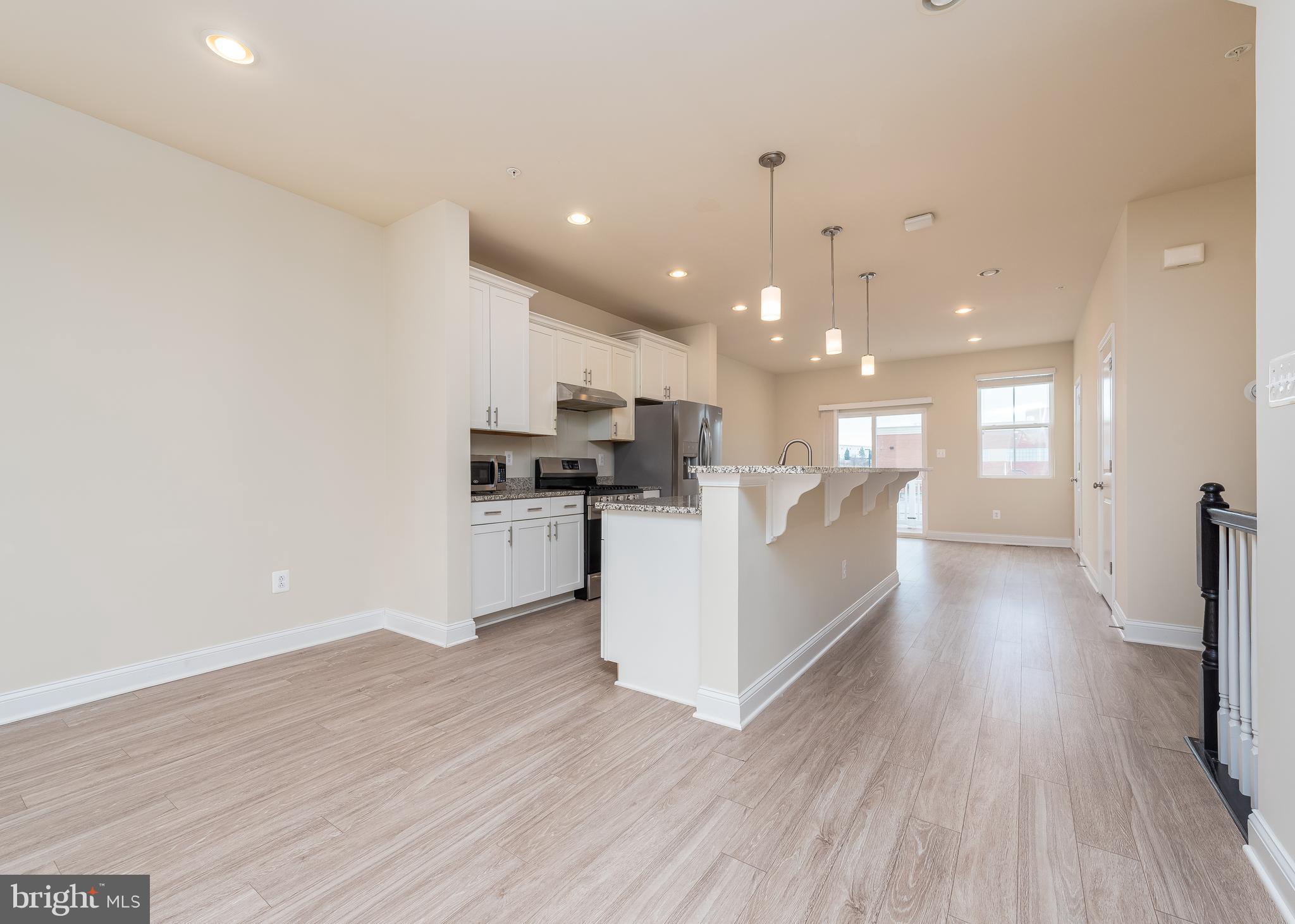 7038 Rackham Way Hanover, MD 21076 - Photo 7 of 30 a view of kitchen with cabinets and wooden floor