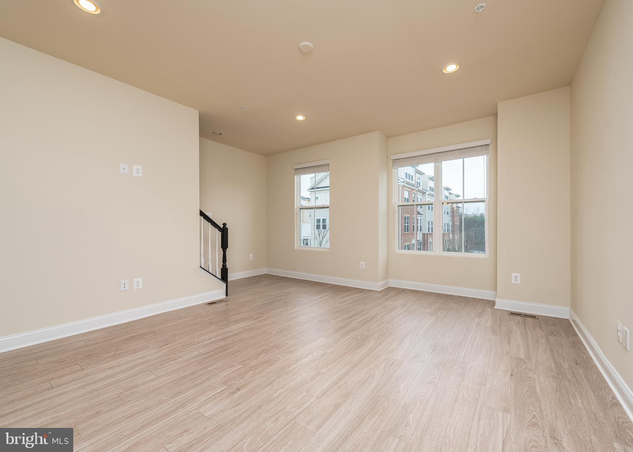 7038 Rackham Way Hanover, MD 21076 - Photo 8 of 30 an empty room with wooden floor and windows