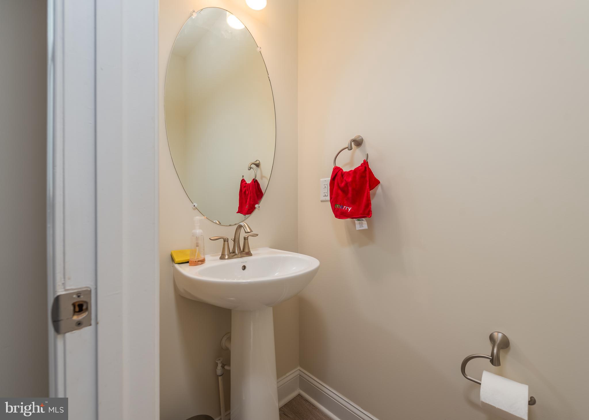 7038 Rackham Way Hanover, MD 21076 - Photo 10 of 30 a bathroom with a sink and a mirror