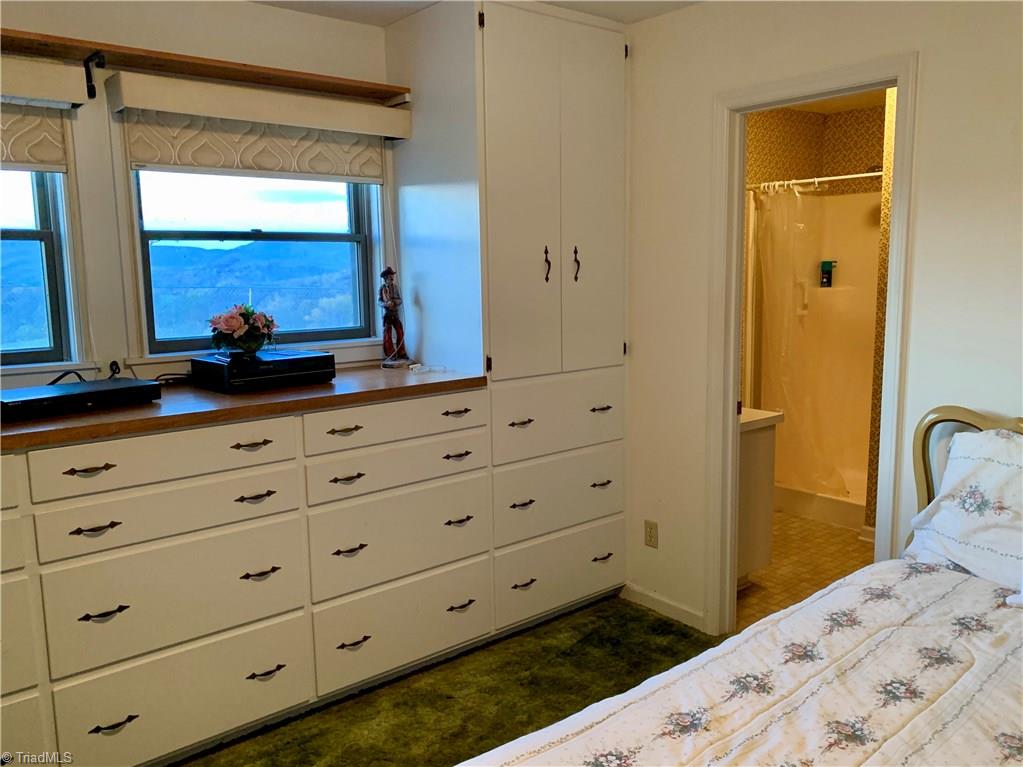 496 Osborne Memorial Road Sparta, NC 28675 - Photo 14 of 30 Master bedroom with massive built-in storage, en suite, and amazing views!