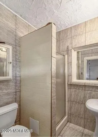 a bathroom with a toilet and shower