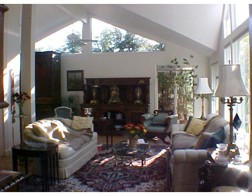 293 Hartman Road Newton, MA 02459 - Photo 5 of 8 a living room with furniture a chandelier and a large mirror