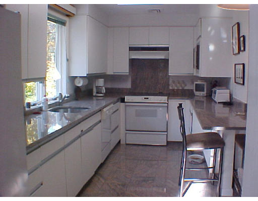 293 Hartman Road Newton, MA 02459 - Photo 6 of 8 a kitchen with granite countertop stainless steel appliances a sink stove and cabinets