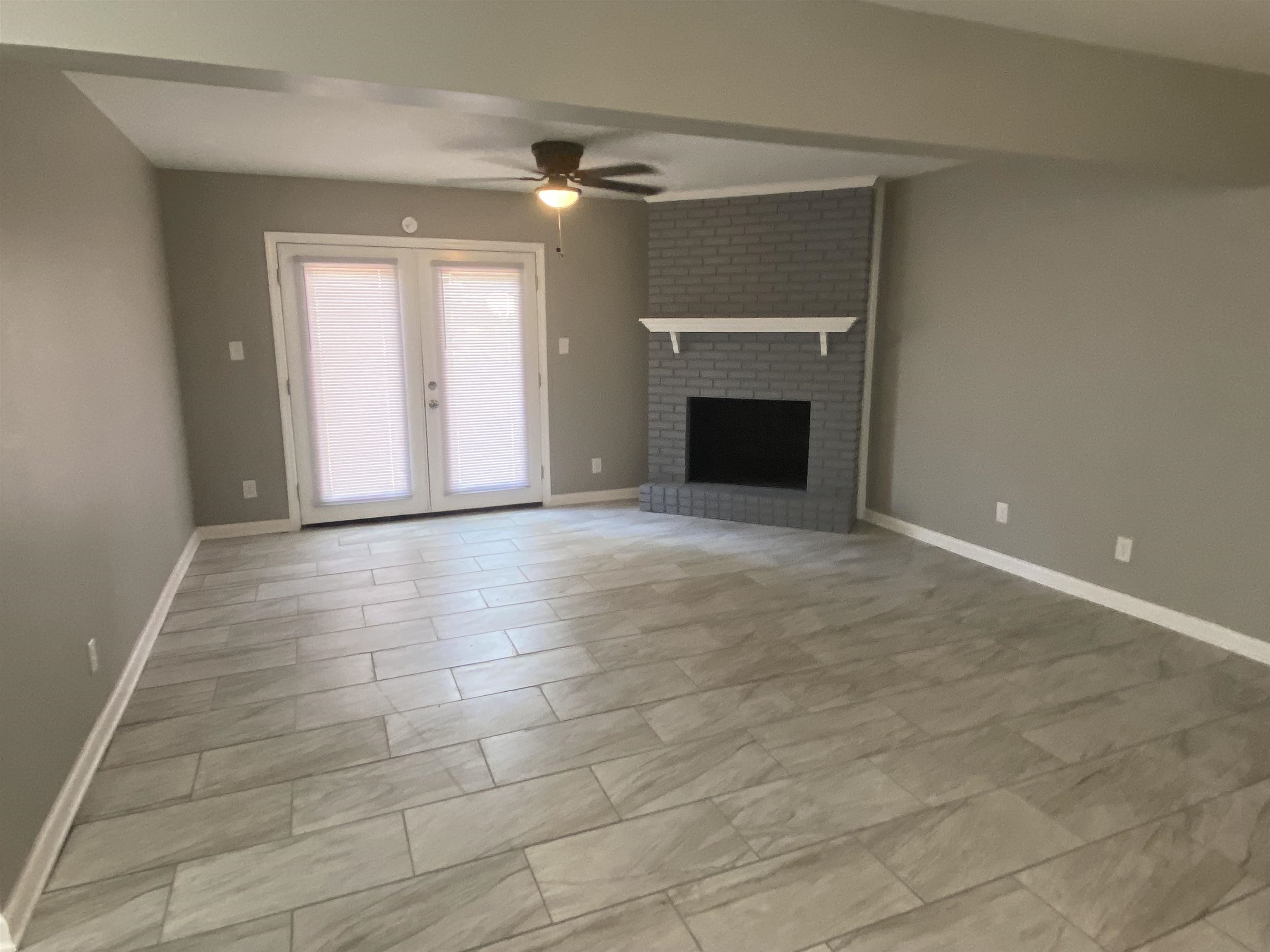 1578 Rabb Road Memphis, TN 38119 - Photo 12 of 23 a view of an empty room with a fireplace and a window