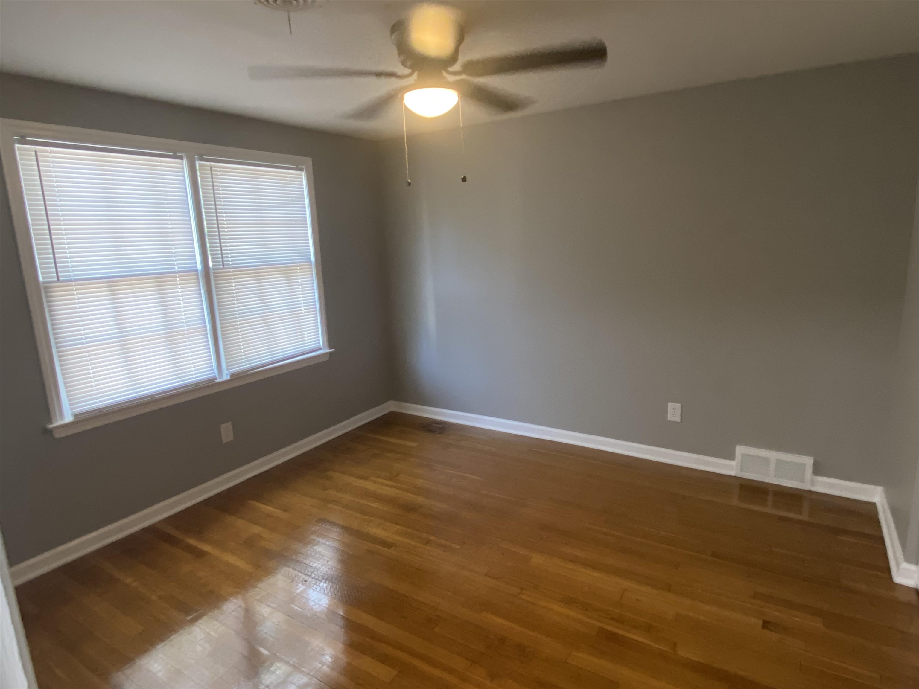 1578 Rabb Road Memphis, TN 38119 - Photo 23 of 23 a view of an empty room with wooden floor and a window