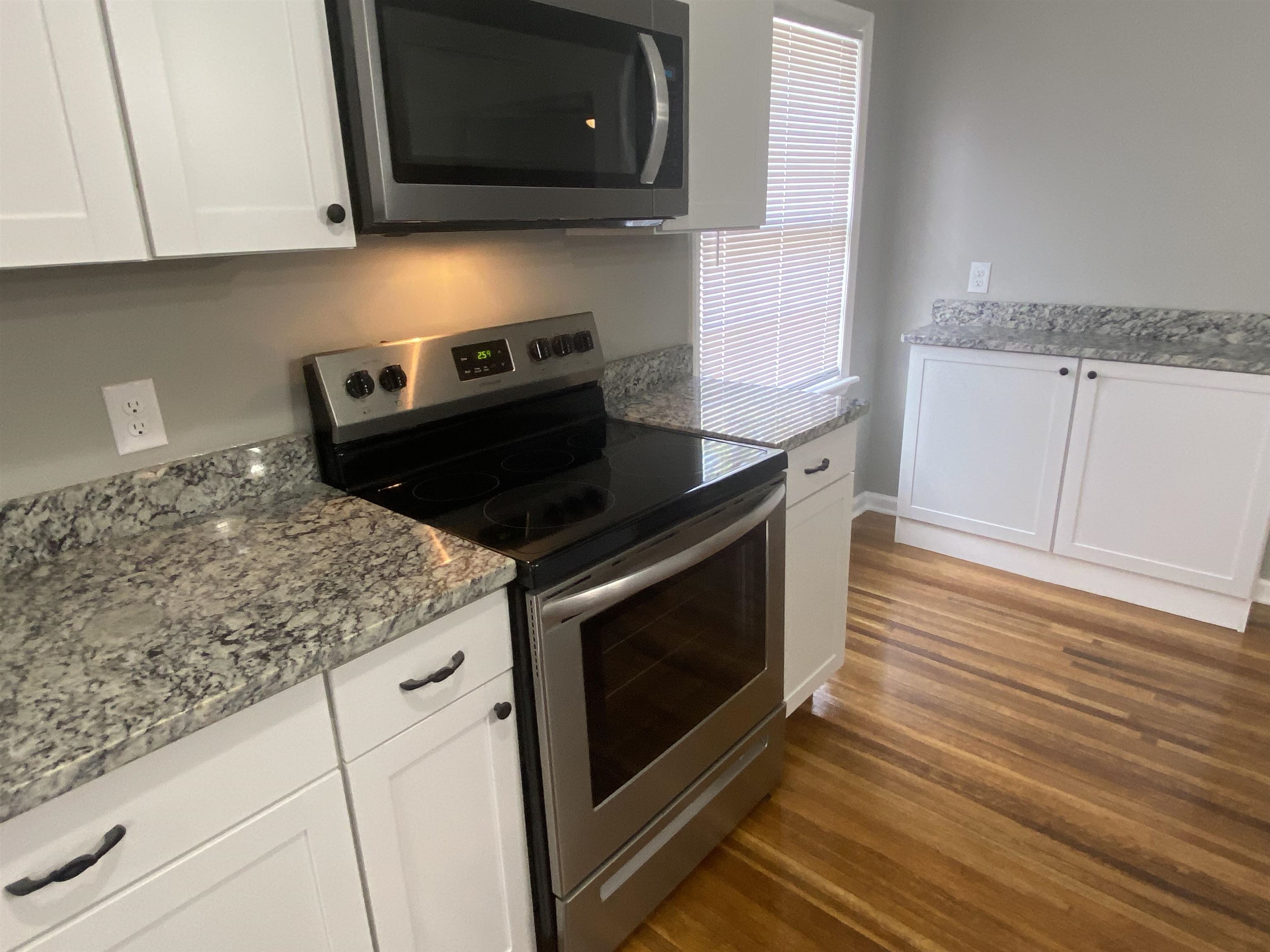 1578 Rabb Road Memphis, TN 38119 - Photo 9 of 23 a kitchen with granite countertop white cabinets stainless steel appliances and sink