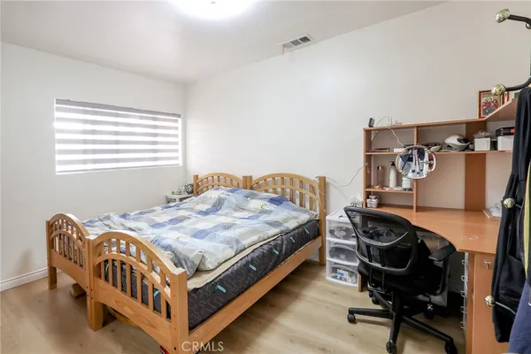 a bedroom with a bed and a desk