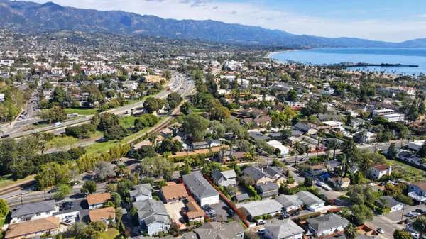 an aerial view of residential house and sandy dunes