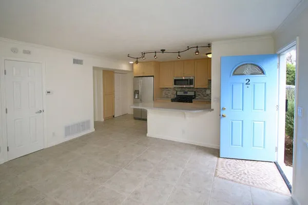 a view of a kitchen with a refrigerator a microwave and a sink