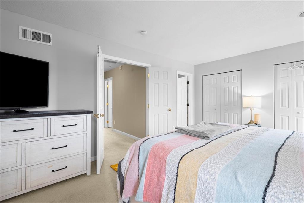 23 Castle View Drive McKees Rocks, PA 15136 - Photo 17 of 27 a bedroom with a bed and a flat screen tv in white cabinets