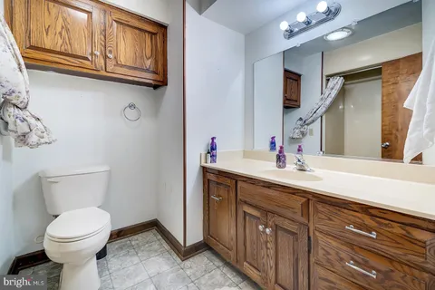 a bathroom with a toilet sink and mirror
