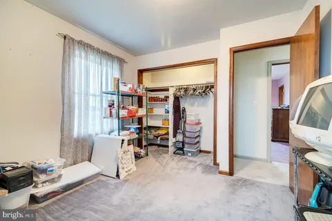 a view of a livingroom with workspace and a window