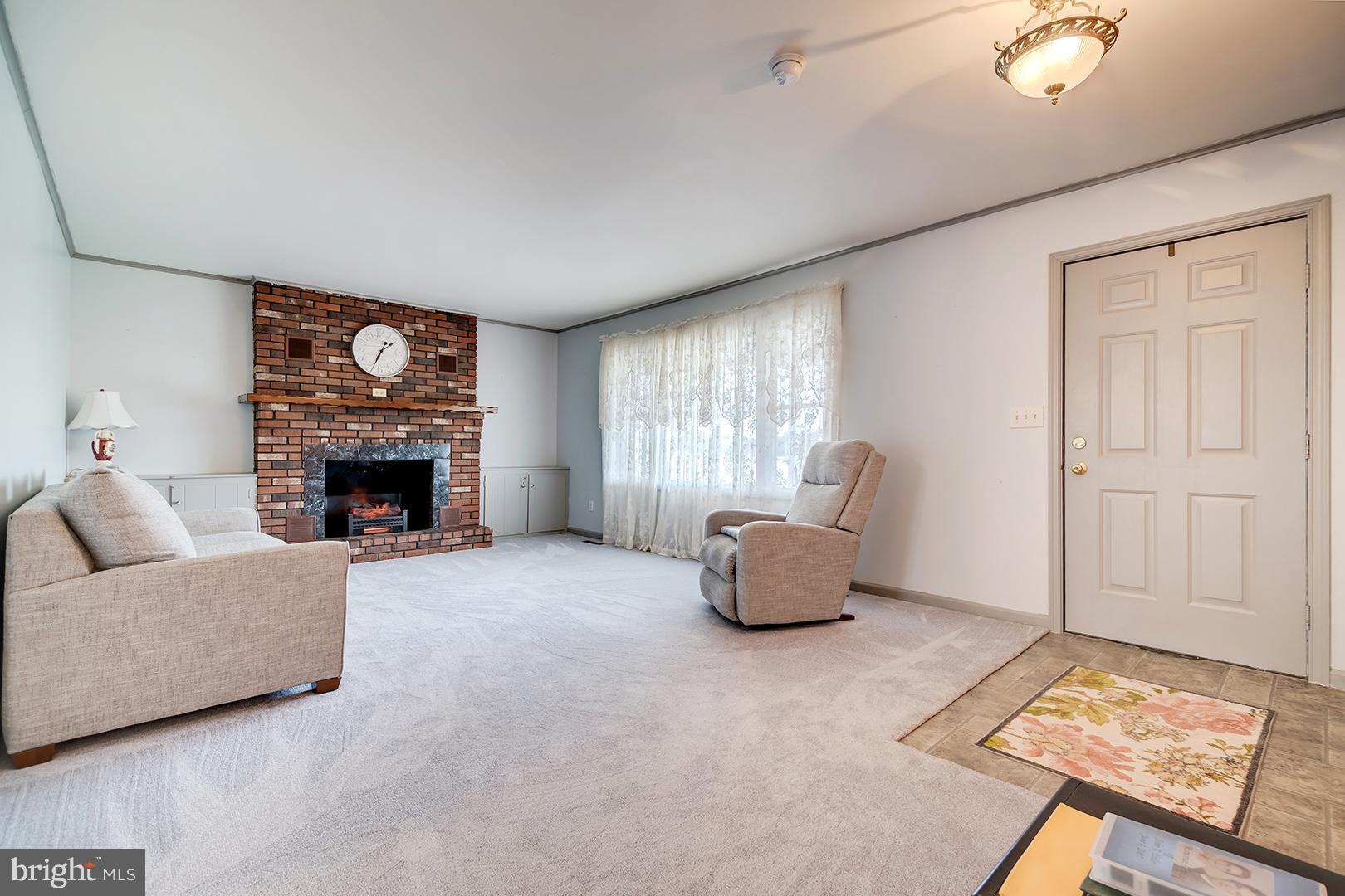 10046 Woodyard Road Greenwood, DE 19950 - Photo 2 of 45 a living room with furniture and a fireplace