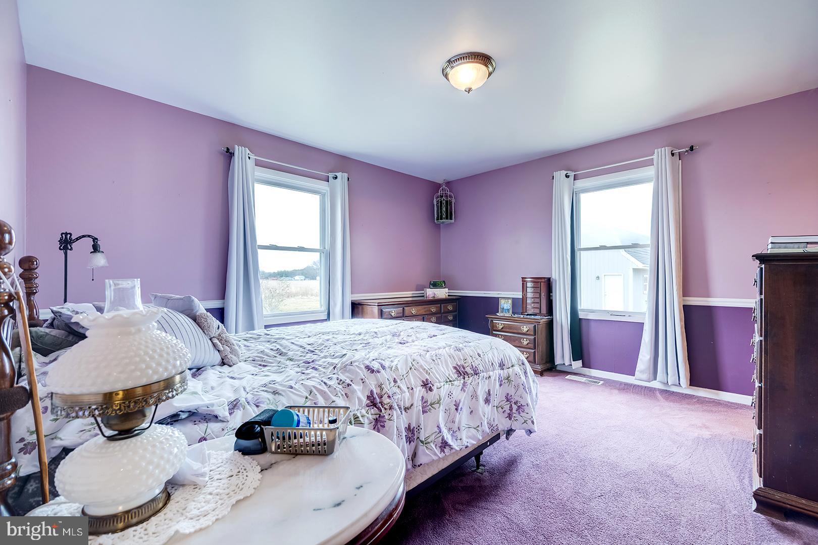 10046 Woodyard Road Greenwood, DE 19950 - Photo 21 of 45 a bedroom with a bed and a chair