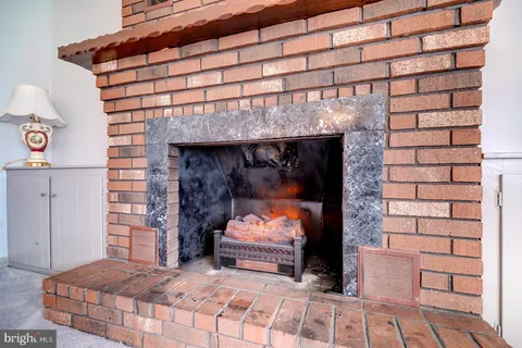 a bedroom with a bed and a fireplace