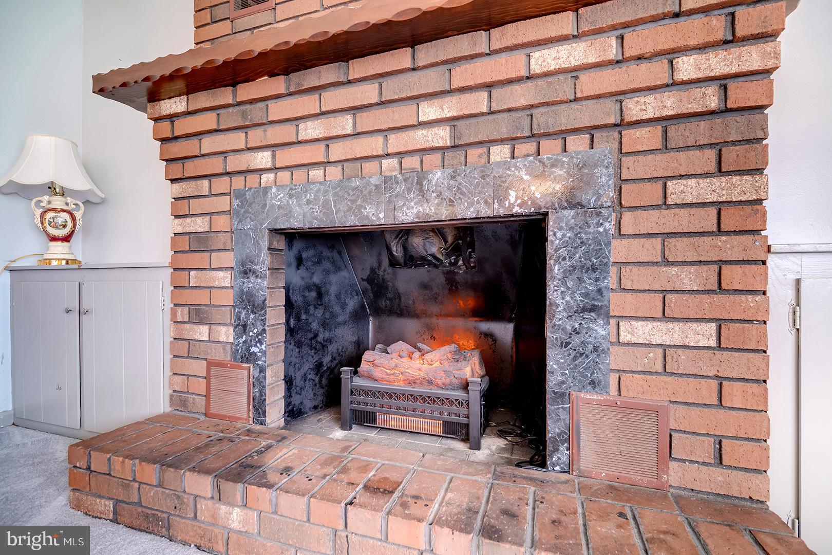 10046 Woodyard Road Greenwood, DE 19950 - Photo 5 of 45 a bedroom with a bed and a fireplace